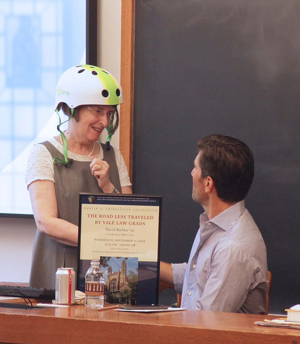 YLS Prof. and Center Dir. Roberta Romano &#039;80 presenting David Richter &#039;92 with a framed Chirelstein Colloquium poster as a gesture of appreciation.