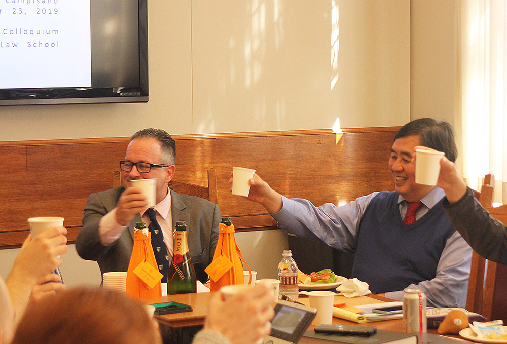 Mark Campisano &#039;80 and YLS Prof. Harold Hongju Koh leading a toast to Marvin A. Chirelstein, for whom the Colloquium was named.
