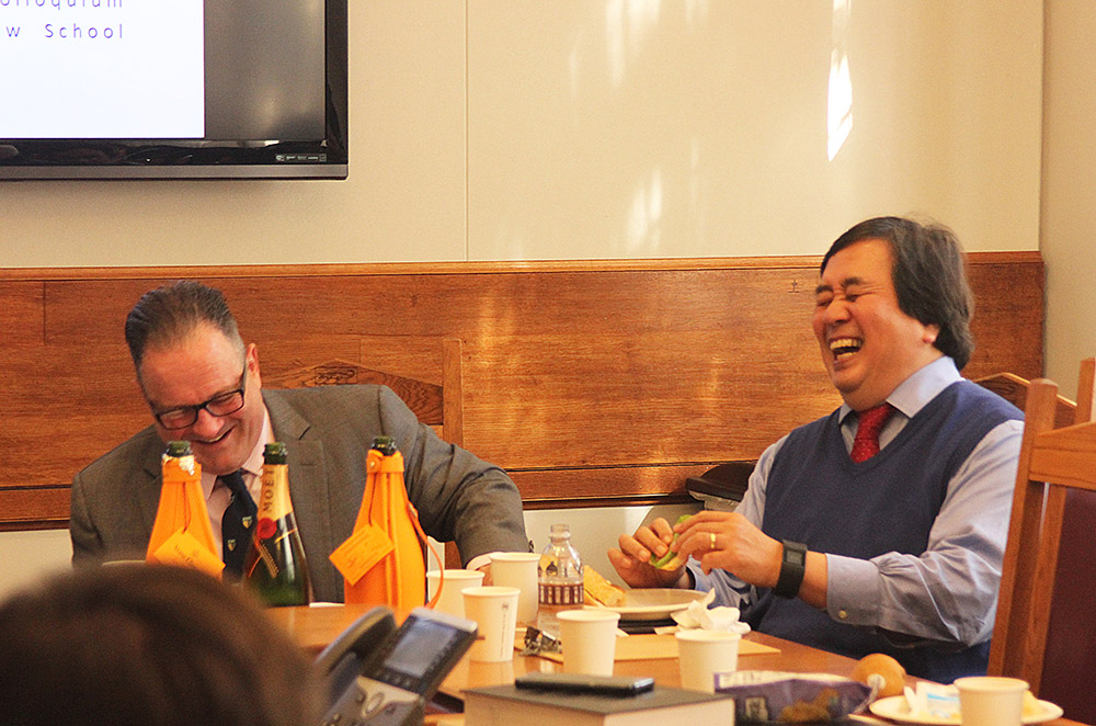 Mark Campisano &#039;80 and YLS Prof. Harold Hongju Koh laughing over a shared memory.