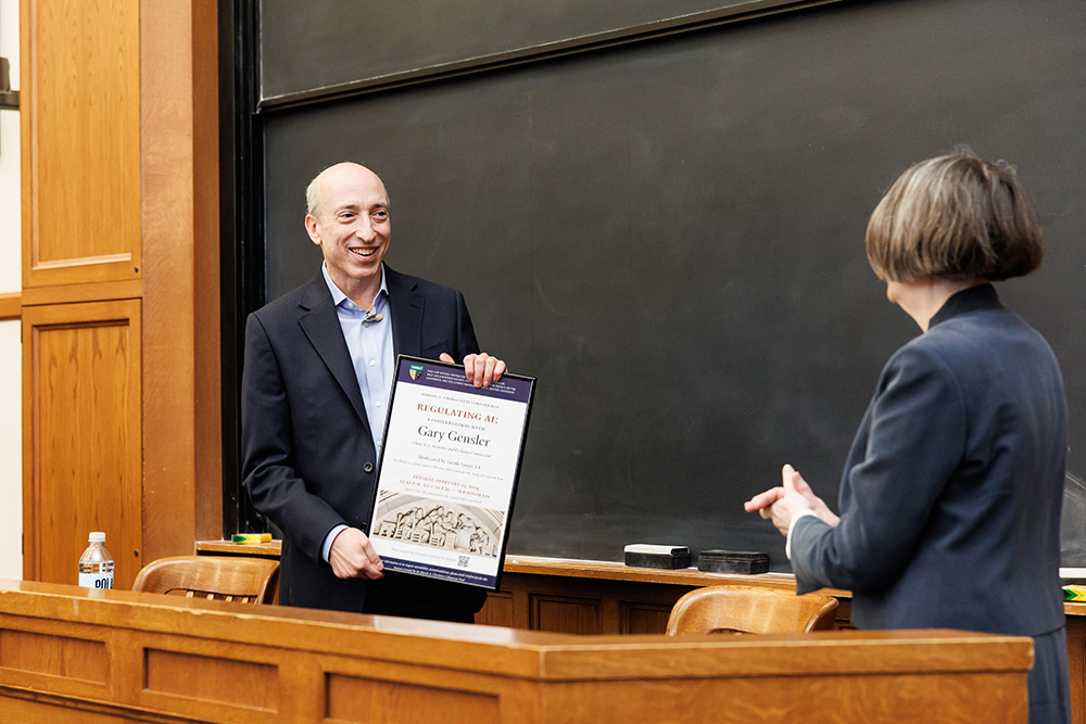 YLS Prof. and Center Co-Dir. Roberta Romano &#039;80 presenting SEC Chair Gary Gensler with a framed Chirelstein Colloquium poster