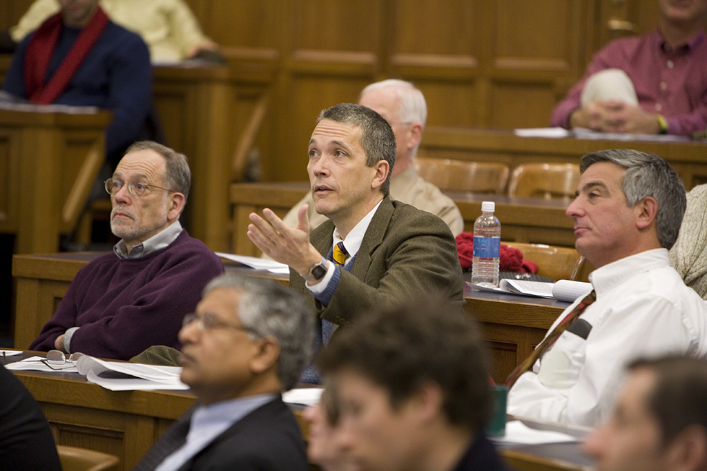 YLS Prof. Ian Ayres &#039;86 asking a question, while YLS Prof. Al Klevorick, Cardozo Law Prof. and YLS Visiting Prof. Edward Zelinsky &#039;75, and Yale SOM Prof. Shyam Sunder look on