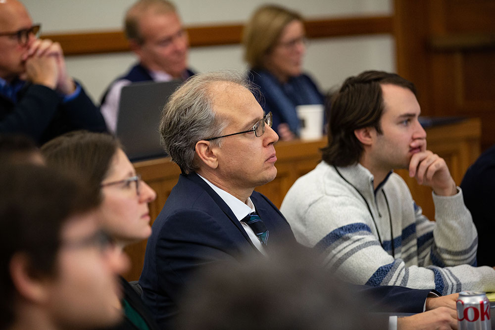Texas Law Prof. Jens Dammann &#039;03 (J.S.D.) (center), Boston College Law Prof. Natalya Shnitser &#039;09 (left), and Kaleb Mount &#039;23 (right) listening
