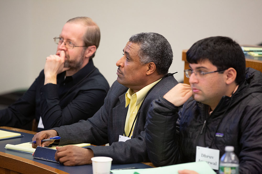 Arwin Zeissler (left), U. of New Haven Prof. Demissew Diro Ejara (center), and Dhruv Aggarwal &#039;20 (right) listen
