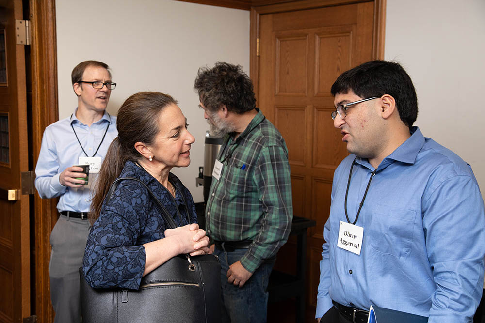 (Foreground) U. of Oklahoma Bus. and Law Prof. Colleen Baker and Northwestern Pritzker Law Prof. Dhruv Aggarwal (J.D. &#039;21/Ph.D. &#039;23) chatting at Roundtable coffee break; (Background) Boston U. Law Prof. Rory Van Loo (Ph.D. &#039;16) and Joseph Sommer &#039;88 chatting at Roundtable coffee break