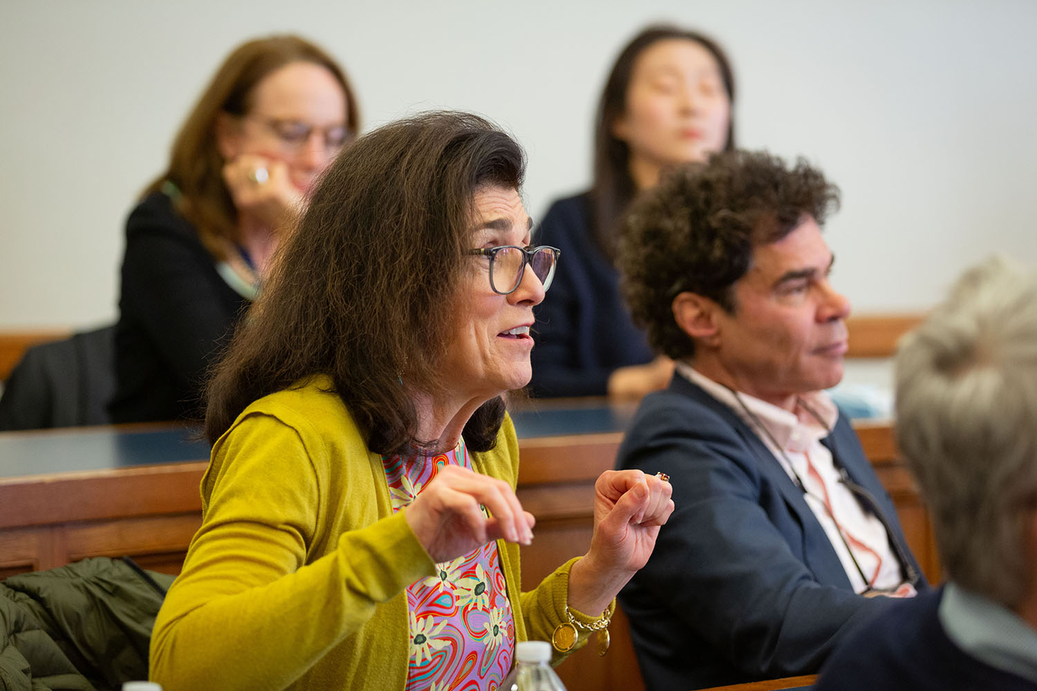 Marianna Ayres (left) asking a question, while Yale Econ. Prof. John Geanakoplos (right) listens