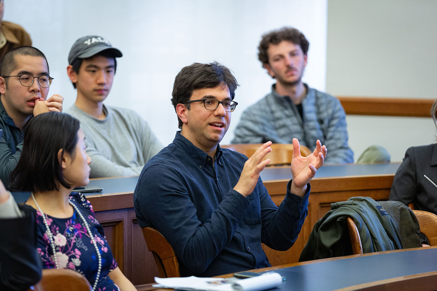YLS Prof. and Center Co-Dir. Sarath Sanga &#039;14 (right) asking a question, while Center Exec. Dir. Nancy Liao &#039;05 (left) listens